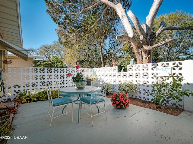 view of patio / terrace featuring outdoor dining area and fence