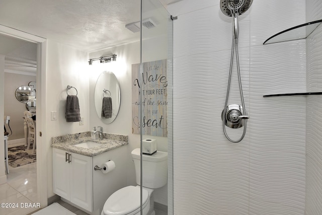 bathroom with vanity, toilet, a textured ceiling, and walk in shower