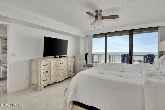 bedroom featuring floor to ceiling windows, ceiling fan, access to exterior, light tile patterned floors, and a textured ceiling