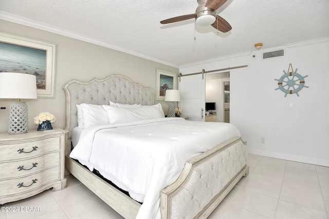 tiled bedroom featuring a barn door, ceiling fan, a textured ceiling, and ornamental molding