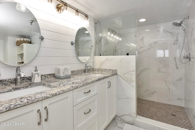 bathroom featuring tiled shower and vanity