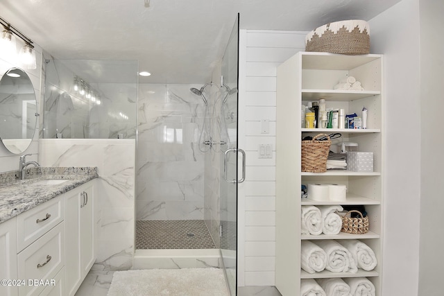 bathroom featuring vanity and a shower with shower door