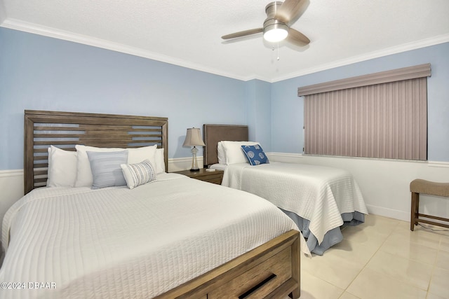 bedroom with a textured ceiling, ceiling fan, ornamental molding, and light tile patterned flooring