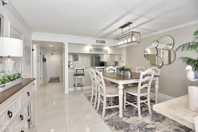 tiled dining space with crown molding and a textured ceiling