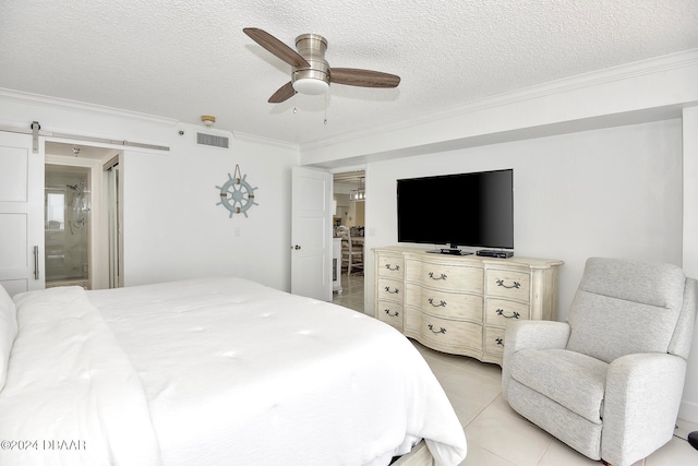 tiled bedroom with ensuite bath, ceiling fan, a barn door, crown molding, and a textured ceiling