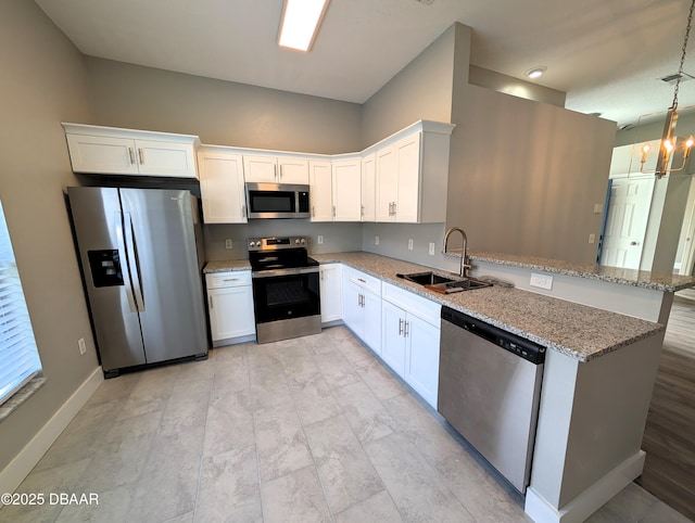 kitchen with white cabinetry, sink, decorative light fixtures, and appliances with stainless steel finishes