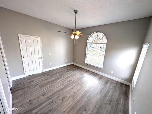 spare room featuring a textured ceiling, dark hardwood / wood-style floors, and ceiling fan