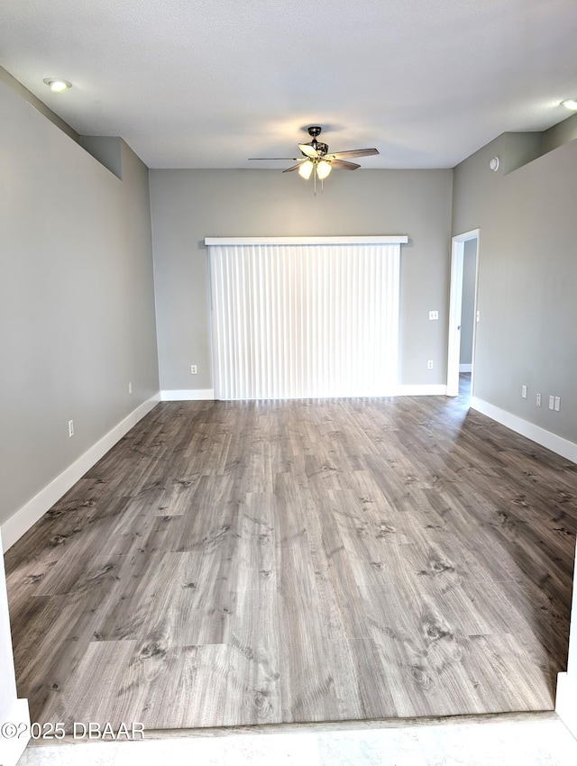 spare room featuring hardwood / wood-style flooring and ceiling fan