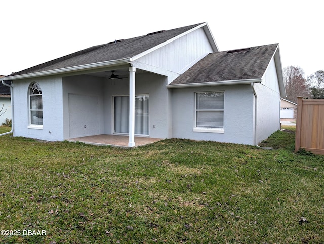 rear view of property featuring a patio, ceiling fan, and a lawn