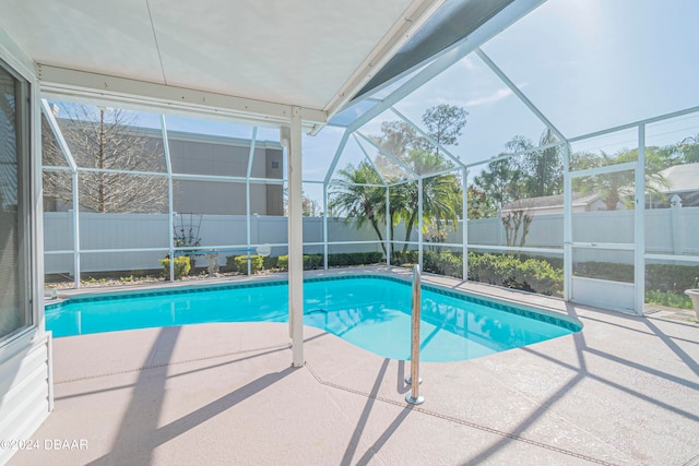 view of pool with a patio and glass enclosure