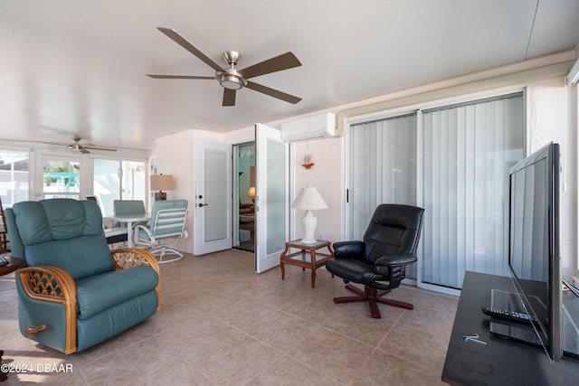 sitting room featuring light tile patterned floors, a wall mounted air conditioner, and ceiling fan