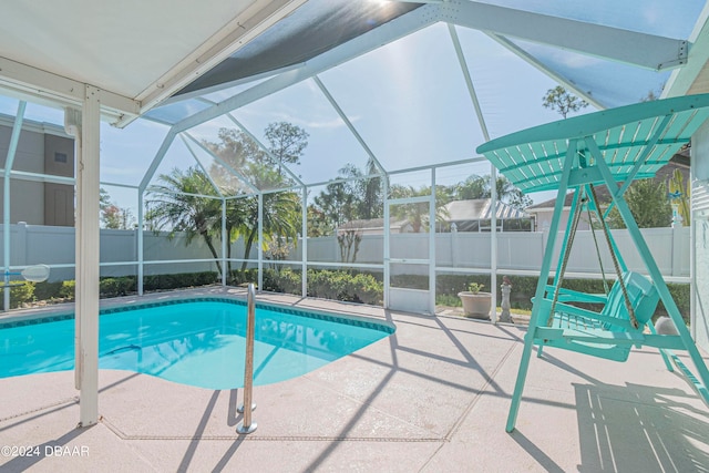 view of pool with a patio area and a lanai