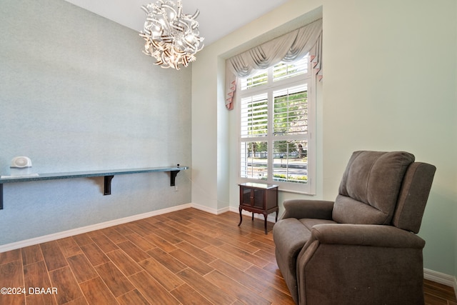 sitting room featuring a chandelier and hardwood / wood-style flooring