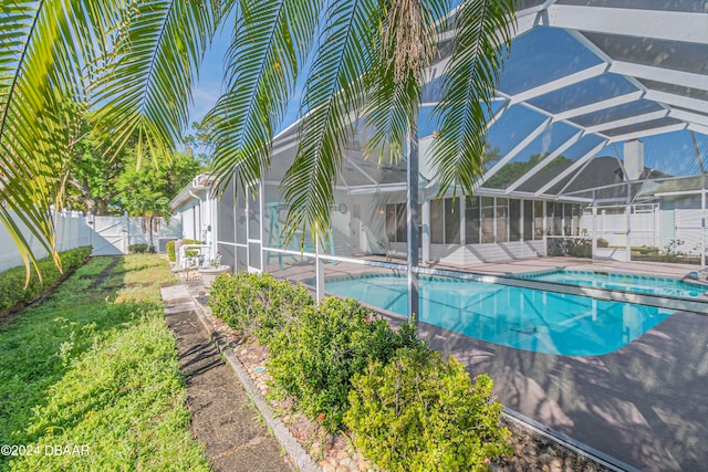 view of pool with a lanai and a patio