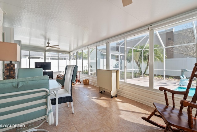 sunroom with ceiling fan and plenty of natural light