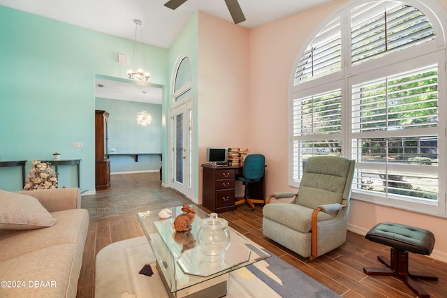 living room with dark hardwood / wood-style flooring and a high ceiling