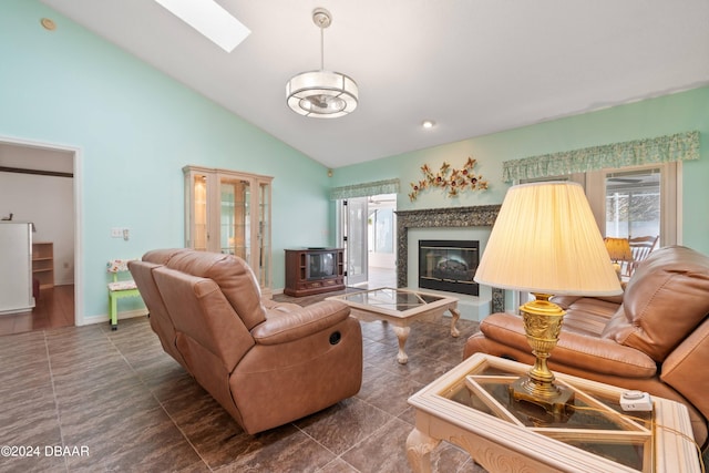 tiled living room with high vaulted ceiling and a skylight