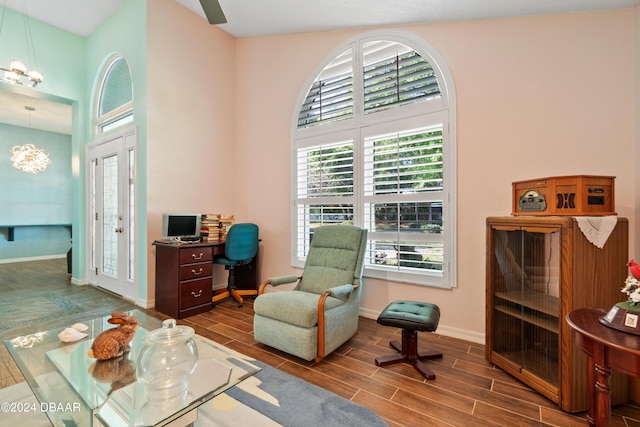 sitting room featuring a notable chandelier and hardwood / wood-style flooring