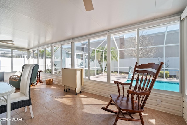 sunroom featuring a healthy amount of sunlight and ceiling fan