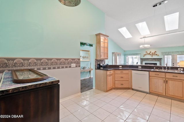 kitchen featuring decorative light fixtures, light tile patterned floors, high vaulted ceiling, sink, and dishwasher