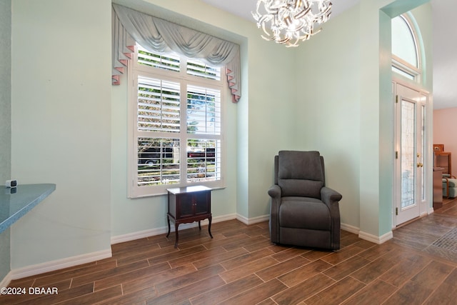 living area featuring dark hardwood / wood-style flooring and a notable chandelier