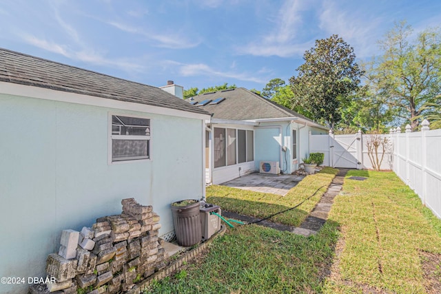 view of yard with ac unit and a patio area