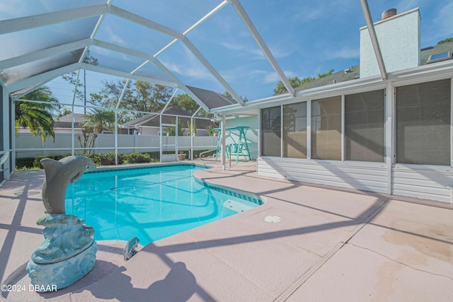 view of swimming pool with a lanai and a patio