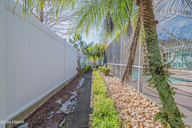 view of yard featuring a lanai and a fenced in pool