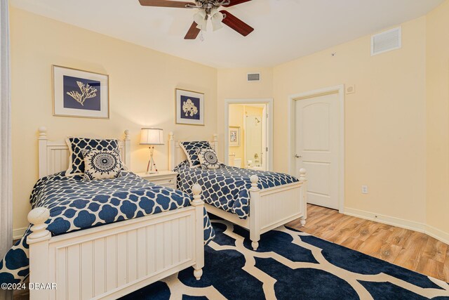 1925 S Atlantic Ave Unit 806, Daytona Beach Shores, FL 32118 - bedroom featuring wood finished floors, ensuite bathroom, ceiling fan, and baseboards