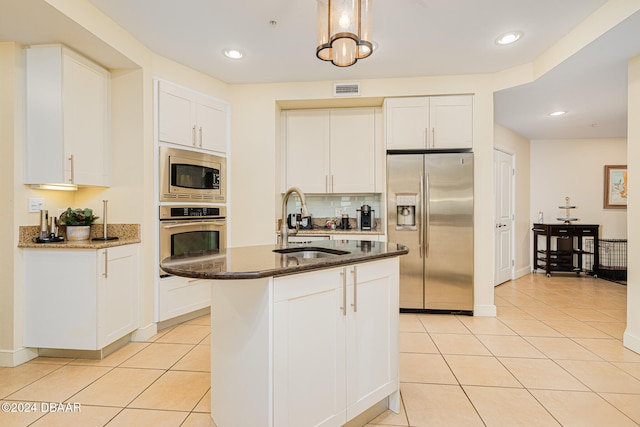 kitchen with white cabinetry, sink, a center island with sink, and stainless steel appliances