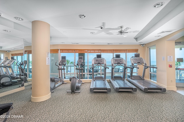 exercise room with ceiling fan and carpet floors