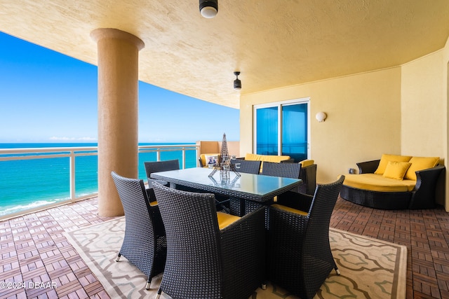 view of patio / terrace with a water view and a balcony