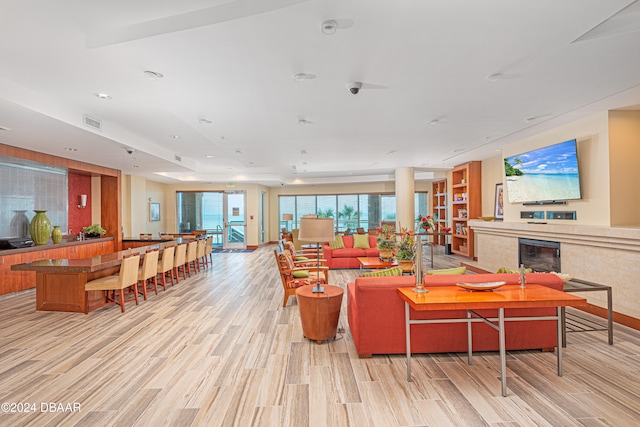 living room featuring a premium fireplace and light hardwood / wood-style floors