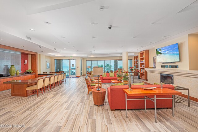 1925 S Atlantic Ave Unit 806, Daytona Beach Shores, FL 32118 - living area with light wood-type flooring, a glass covered fireplace, and recessed lighting