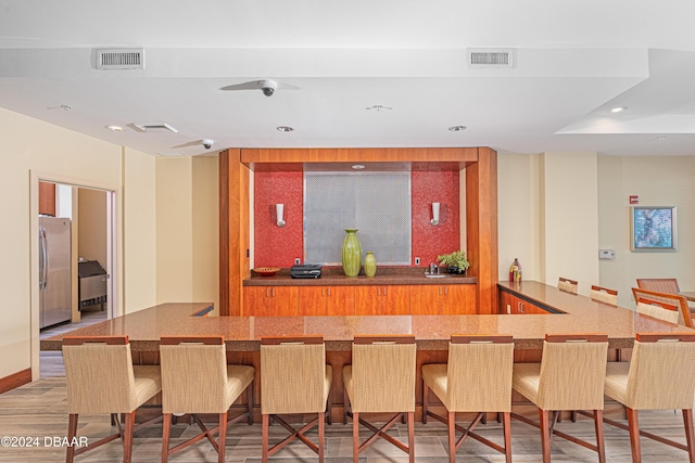 1925 S Atlantic Ave Unit 806, Daytona Beach Shores, FL 32118 - dining room featuring bar with sink, light wood-style flooring, and recessed lighting