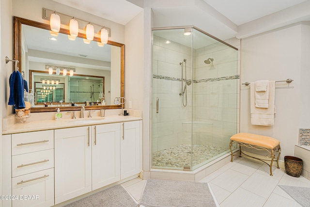 bathroom featuring vanity, a shower with door, and tile patterned flooring