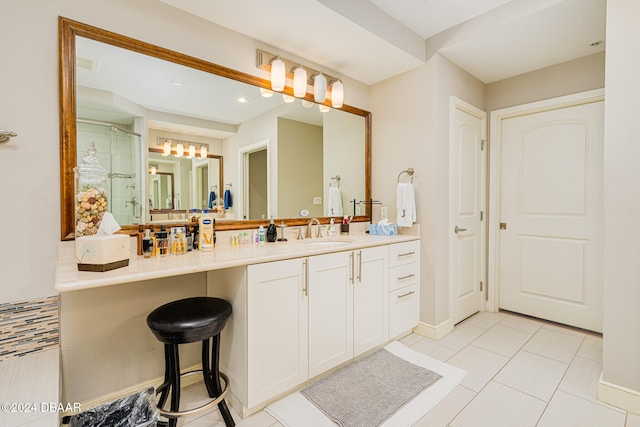 bathroom with walk in shower, vanity, and tile patterned floors