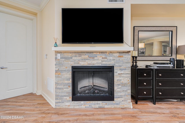 details featuring a fireplace, hardwood / wood-style flooring, and crown molding