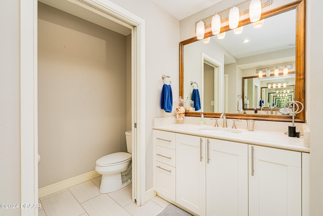 bathroom with vanity, tile patterned floors, and toilet