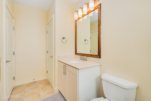 bathroom with toilet and vanity