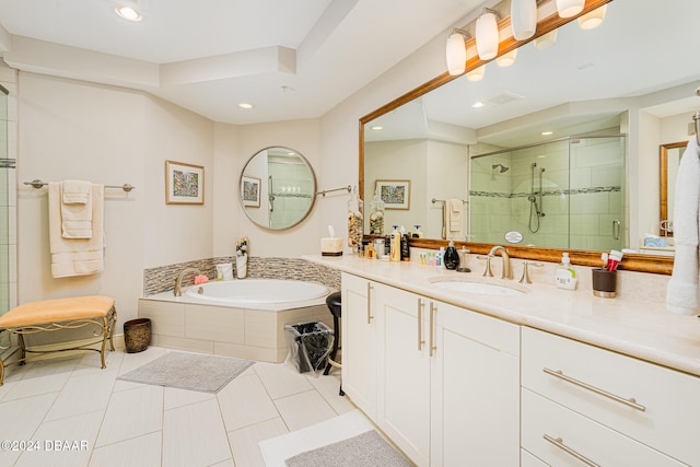 bathroom featuring shower with separate bathtub, tile patterned floors, and vanity