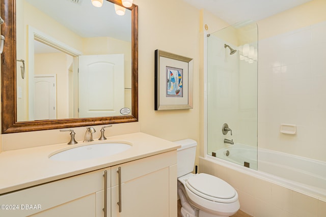 full bathroom with vanity, tiled shower / bath, and toilet