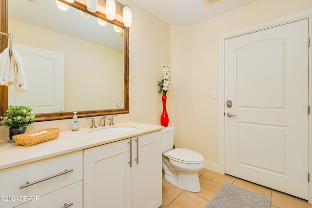 bathroom featuring toilet, vanity, and tile patterned floors