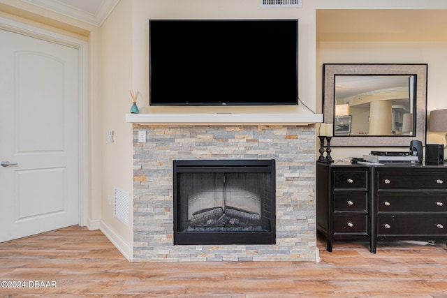 1925 S Atlantic Ave Unit 806, Daytona Beach Shores, FL 32118 - detailed view of ornamental molding, a stone fireplace, wood finished floors, and baseboards