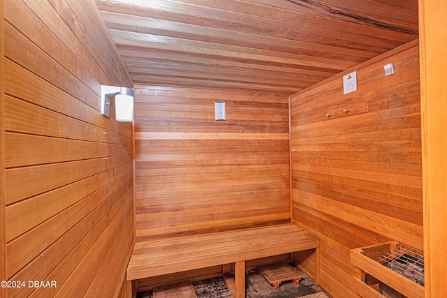 view of sauna / steam room featuring wooden walls and wood ceiling