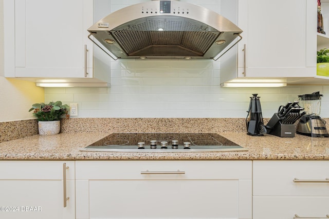 1925 S Atlantic Ave Unit 806, Daytona Beach Shores, FL 32118 - kitchen featuring ventilation hood, black electric cooktop, white cabinetry, and backsplash