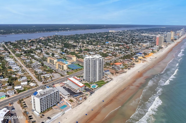 drone / aerial view featuring a water view and a beach view