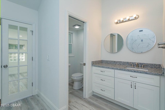 640 Old Treeline Trl, Deland, FL 32724 - bathroom featuring wood finished floors, toilet, vanity, and baseboards
