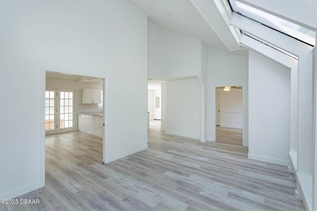 640 Old Treeline Trl, Deland, FL 32724 - unfurnished living room with light wood-type flooring, high vaulted ceiling, baseboards, and ceiling fan