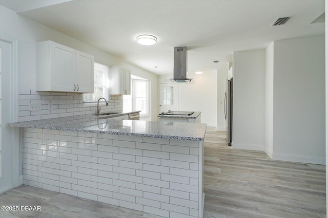 640 Old Treeline Trl, Deland, FL 32724 - kitchen with extractor fan, a sink, appliances with stainless steel finishes, a peninsula, and light stone counters
